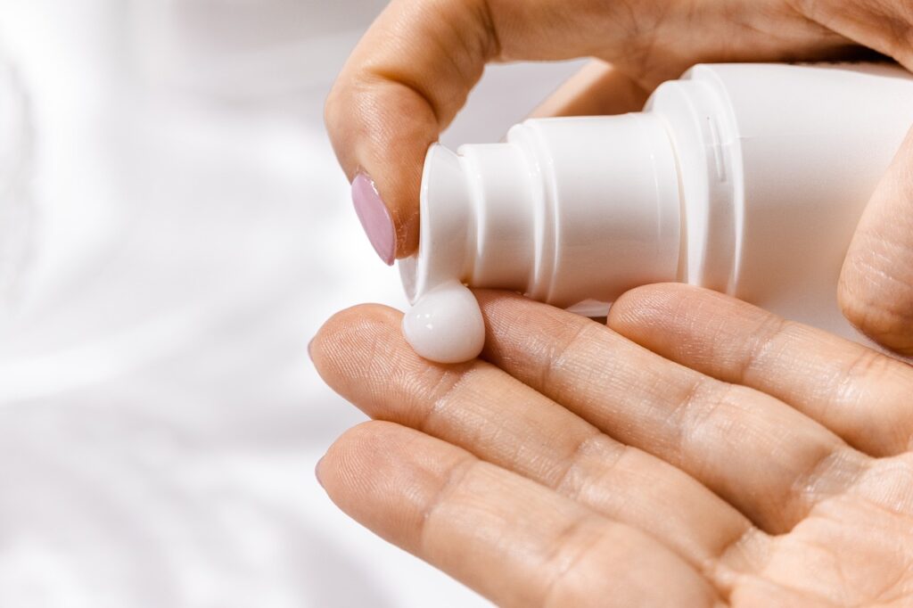 Woman putting lotion with preservatives in her hand